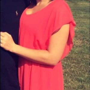 Salmon colored, airy dress.